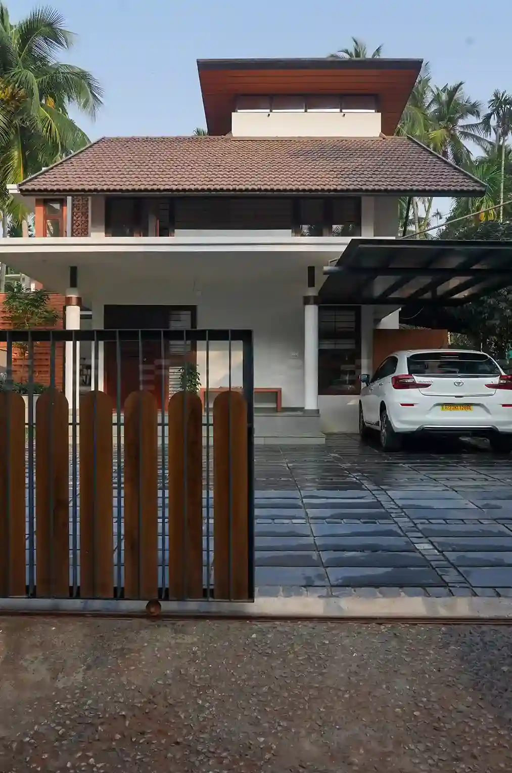 Contemporary sloped-roof design blending clay tiles with modern lines, crafted by a leading Malappuram's top residential architects.