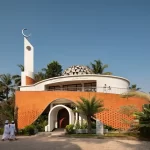 Modern mosque design in Kerala featuring contemporary masjid architecture with dome, minaret, and curved brick facade
