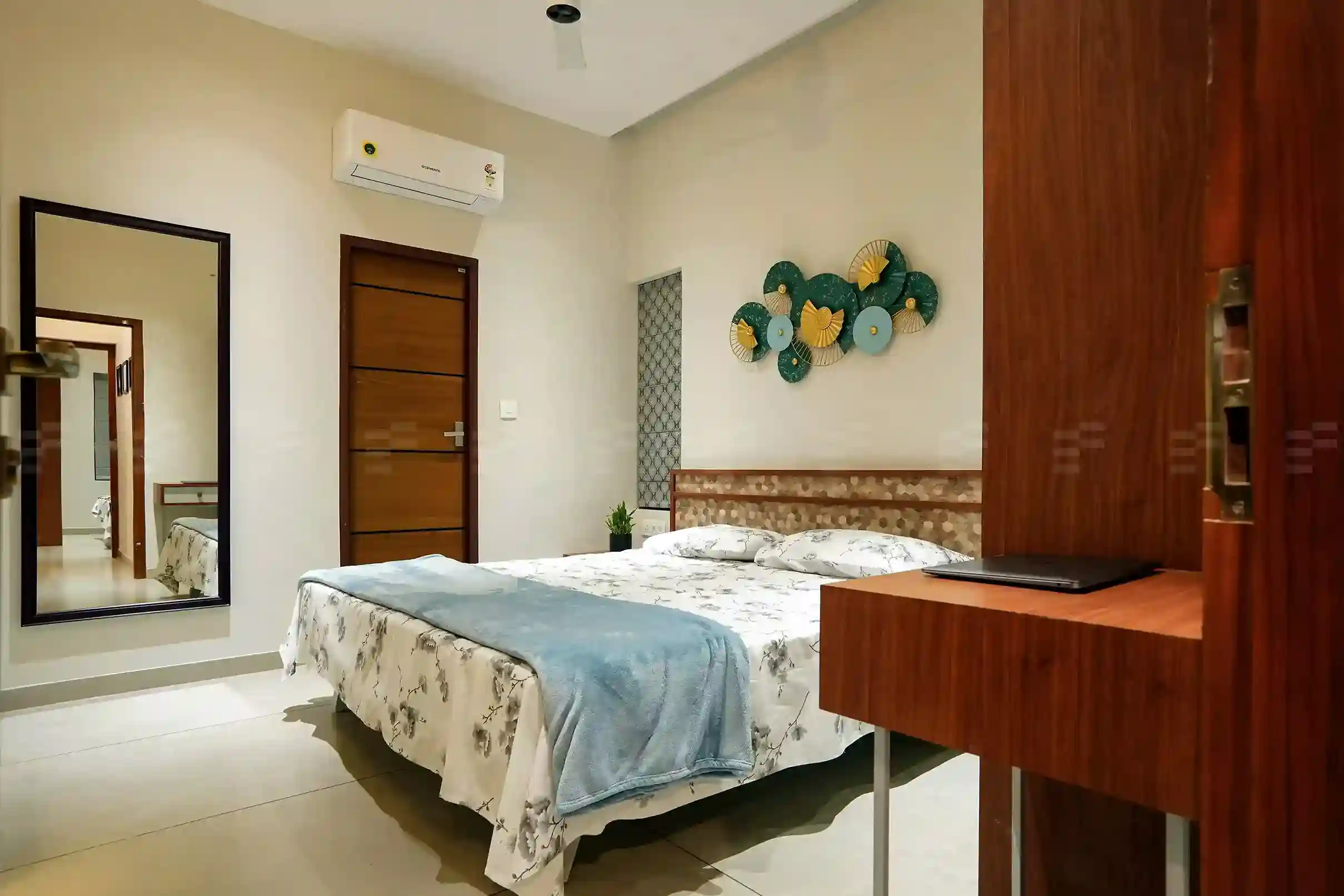 Calm bedroom layout by top residential architects with warm lighting and custom wood furnishings.