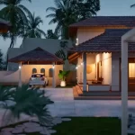 Traditional Kerala-style home with sloping roof, wooden pillars, and a serene courtyard designed by expert architects
