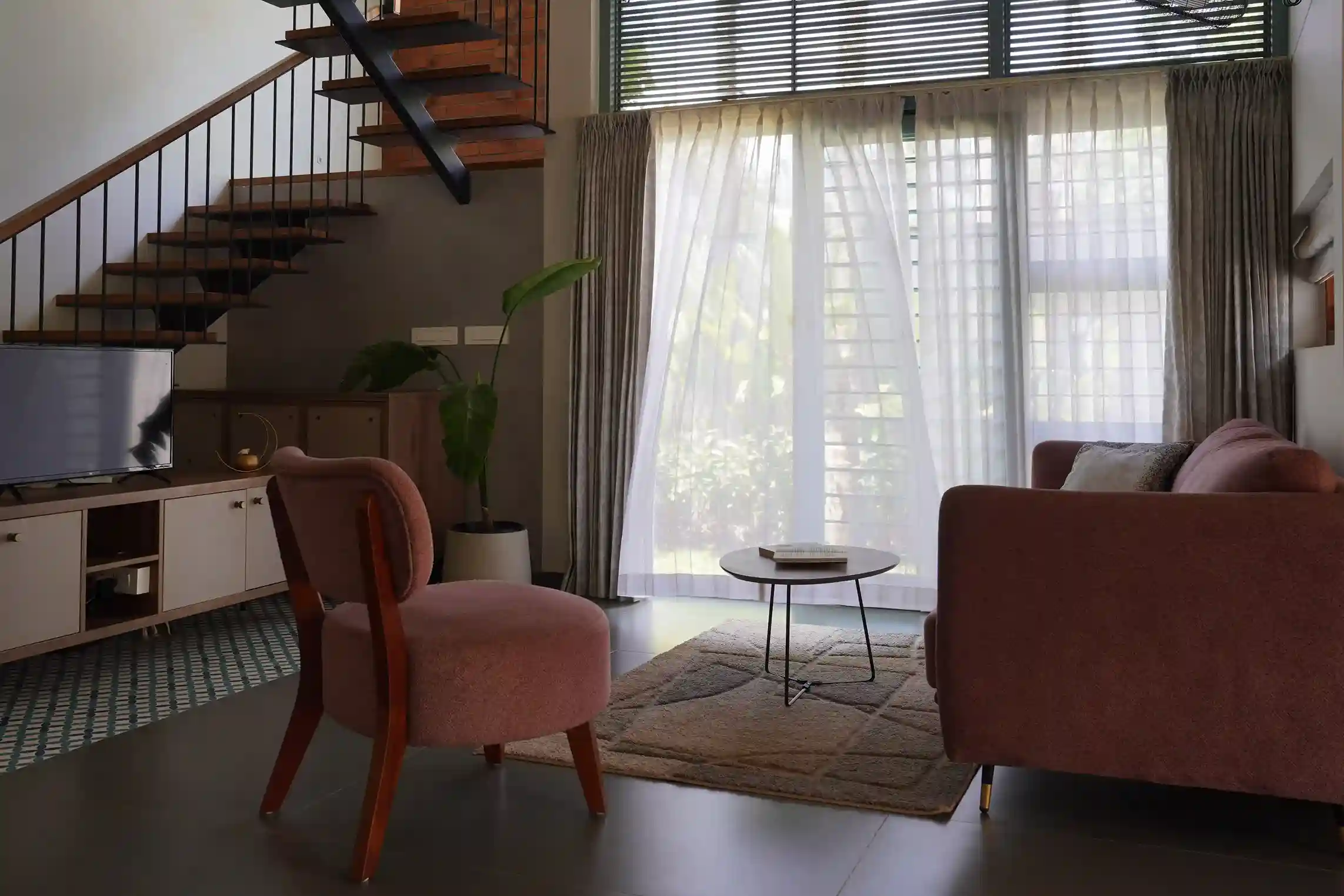 Contemporary house design Kerala living space with full-height windows and natural lighting