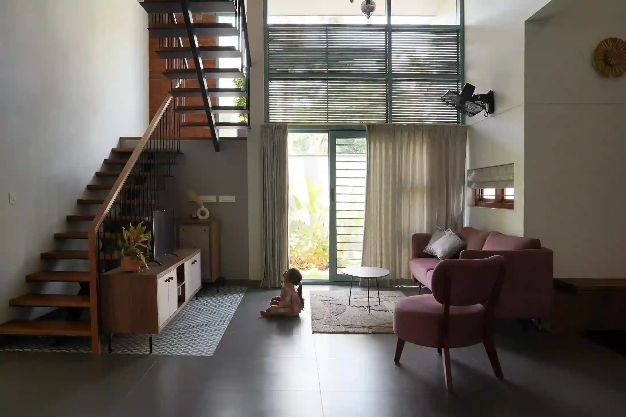 Contemporary house design Kerala living area with floating steel and wood staircase
