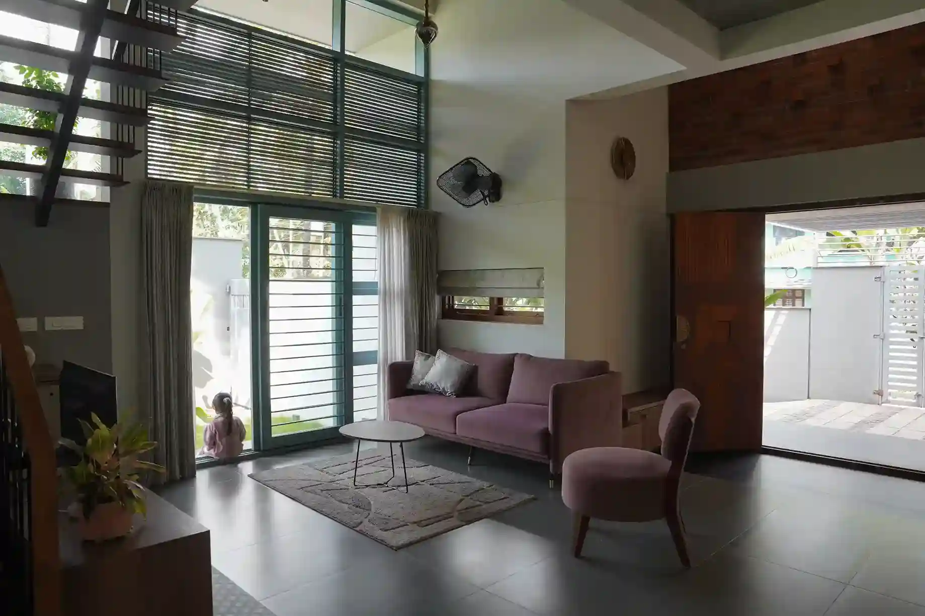 Contemporary house design Kerala living room interior with muted furniture and rug layout