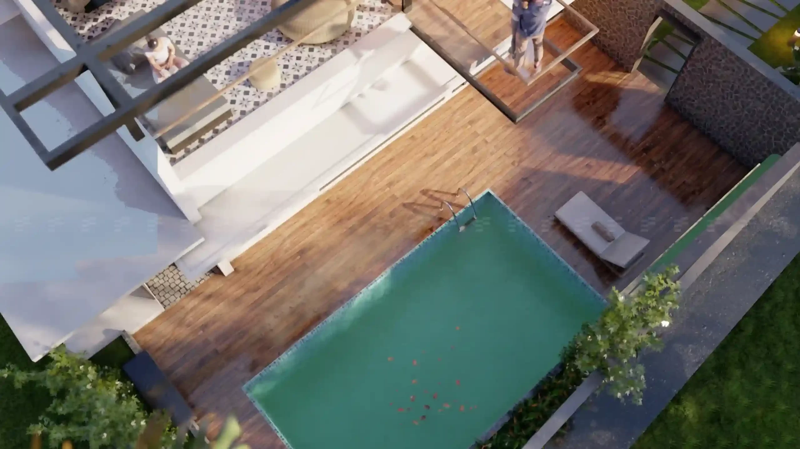Kerala tropical house design featuring a private poolside deck with warm wooden flooring and patterned patio seating.