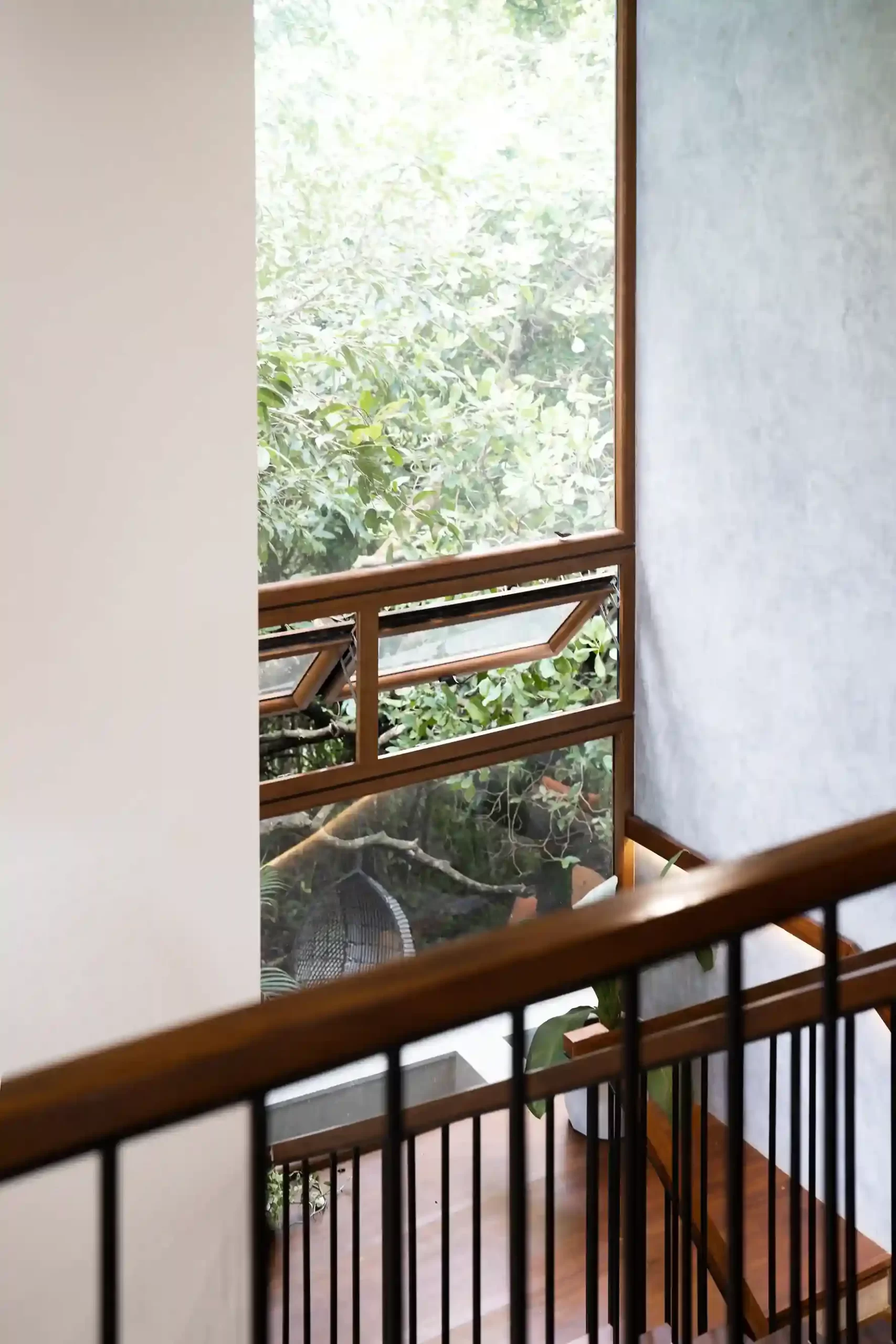 Kymara-vettukad-stair-landing-window-green-view