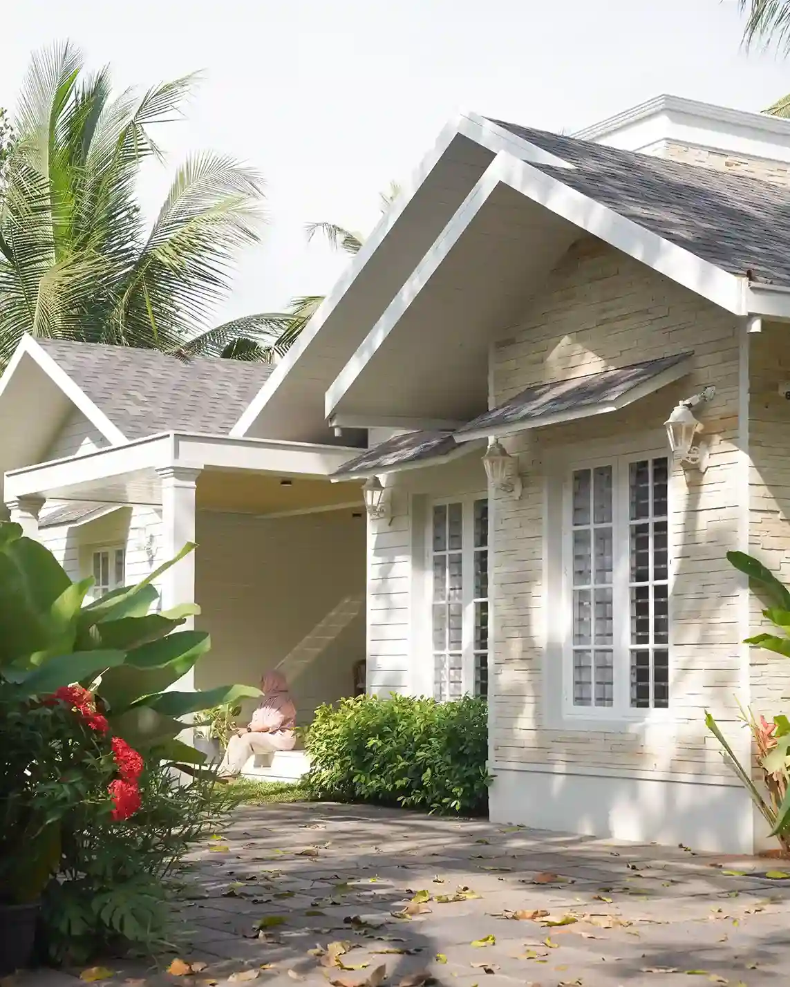 Colonial Style House in Kondotty – 5th Avenue residence featuring sloped roof design and elegant Kerala colonial architecture.